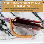 Side view of the hand-carved olive wood wine bottle holder showing its natural grain