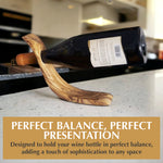 Angled view of the olive wood wine bottle holder with the bottle neck through the opening