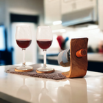 Handmade olive wood wine bottle holder on a plain background